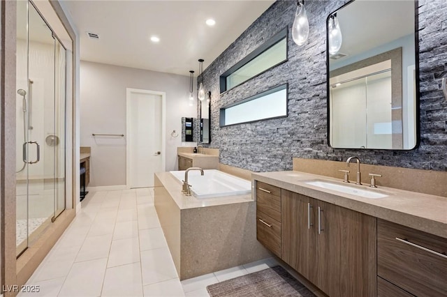 bathroom with a shower stall, a garden tub, tile patterned floors, a sink, and two vanities