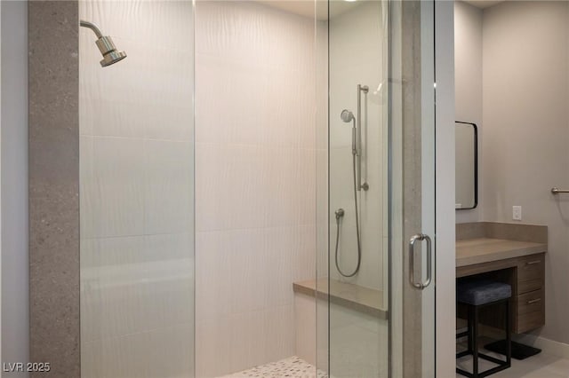 bathroom featuring vanity and a shower stall