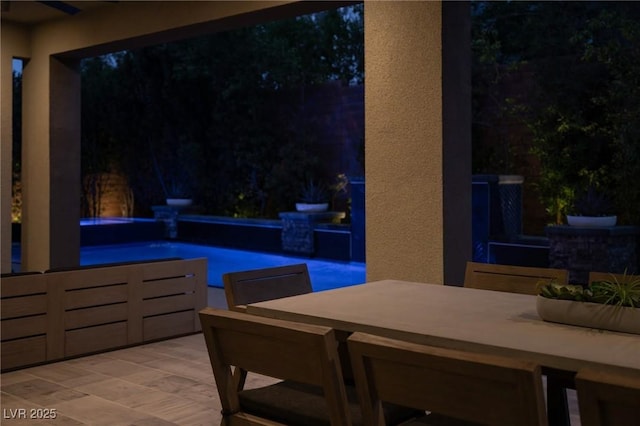 view of patio with an outdoor pool and outdoor dining space