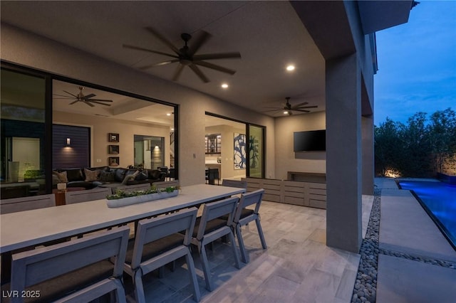 view of patio / terrace featuring ceiling fan, an outdoor pool, and outdoor dining space
