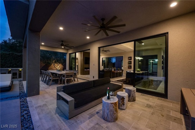 view of patio / terrace with outdoor lounge area, a ceiling fan, and outdoor dining space