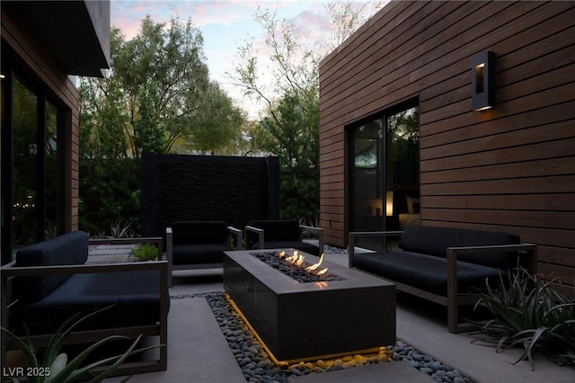 view of patio / terrace featuring an outdoor living space with a fire pit