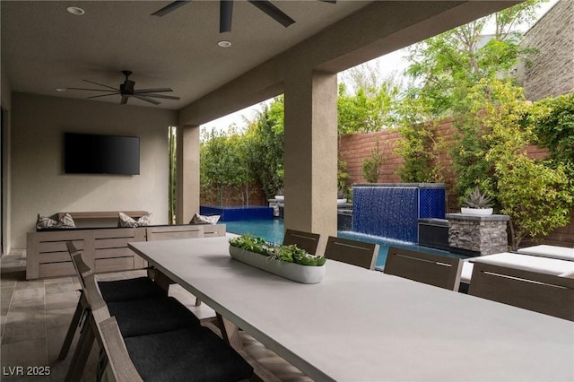 view of patio / terrace featuring area for grilling, ceiling fan, a fenced backyard, and outdoor dining space