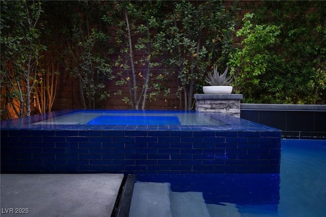 outdoor pool with a hot tub
