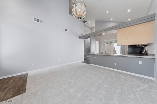 7589 Grassy Bank St, Las Vegas, NV 89139 - unfurnished living room featuring recessed lighting, carpet flooring, stairway, lofted ceiling, and baseboards