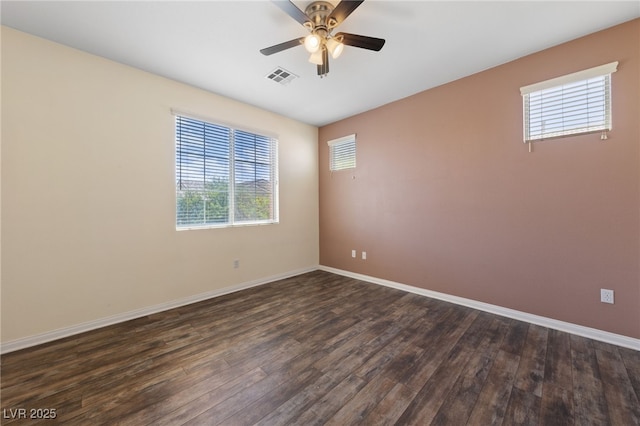 7589 Grassy Bank St, Las Vegas, NV 89139 - unfurnished room featuring dark wood-style flooring, ceiling fan, and baseboards
