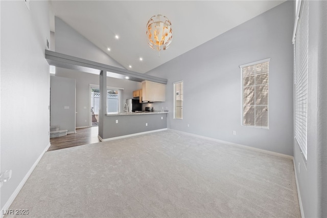 7589 Grassy Bank St, Las Vegas, NV 89139 - unfurnished living room with carpet flooring, a chandelier, baseboards, recessed lighting, and high vaulted ceiling