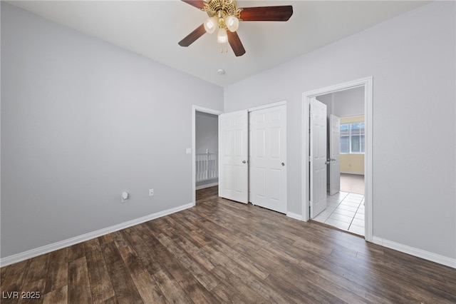 7589 Grassy Bank St, Las Vegas, NV 89139 - unfurnished bedroom with wood finished floors, baseboards, a closet, and a ceiling fan