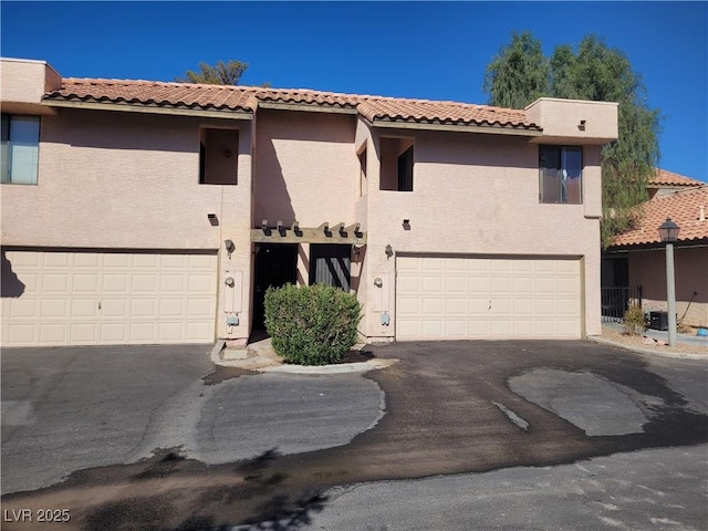 3621 Laguna Verde Way, Las Vegas, NV 89121 - view of front facade featuring a garage, a tile roof, stucco siding, and driveway