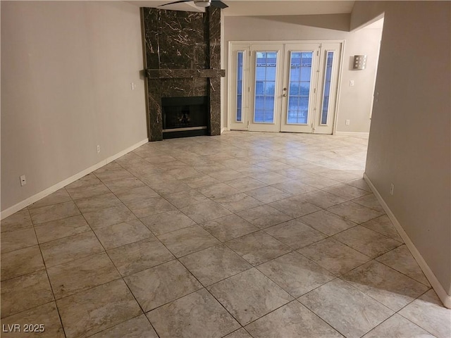 3621 Laguna Verde Way, Las Vegas, NV 89121 - unfurnished living room featuring tile patterned floors, baseboards, and a high end fireplace