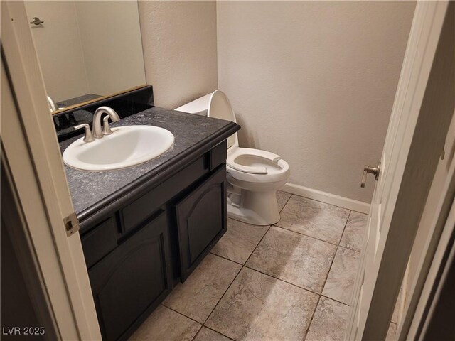 3621 Laguna Verde Way, Las Vegas, NV 89121 - half bathroom featuring tile patterned floors, vanity, a textured wall, baseboards, and toilet