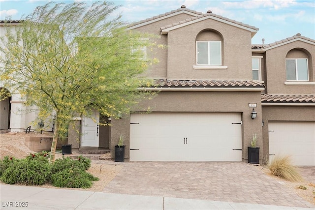 376 Yellow Finch Ln, Henderson, NV 89012 - view of front of property with a tile roof, an attached garage, decorative driveway, and stucco siding