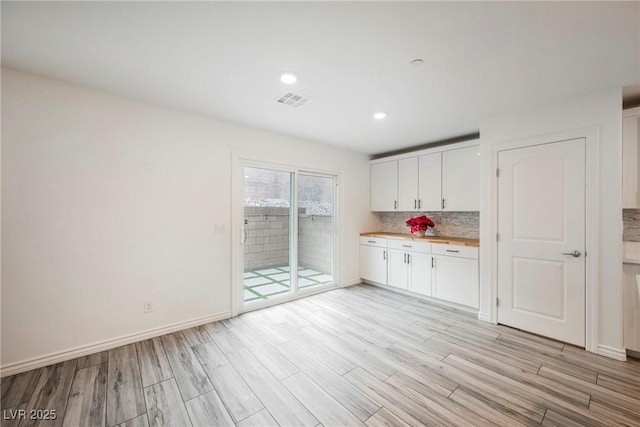 376 Yellow Finch Ln, Henderson, NV 89012 - kitchen featuring white cabinets, light wood-type flooring, decorative backsplash, baseboards, and recessed lighting