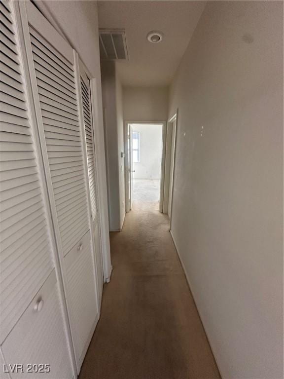 hall featuring light carpet and visible vents