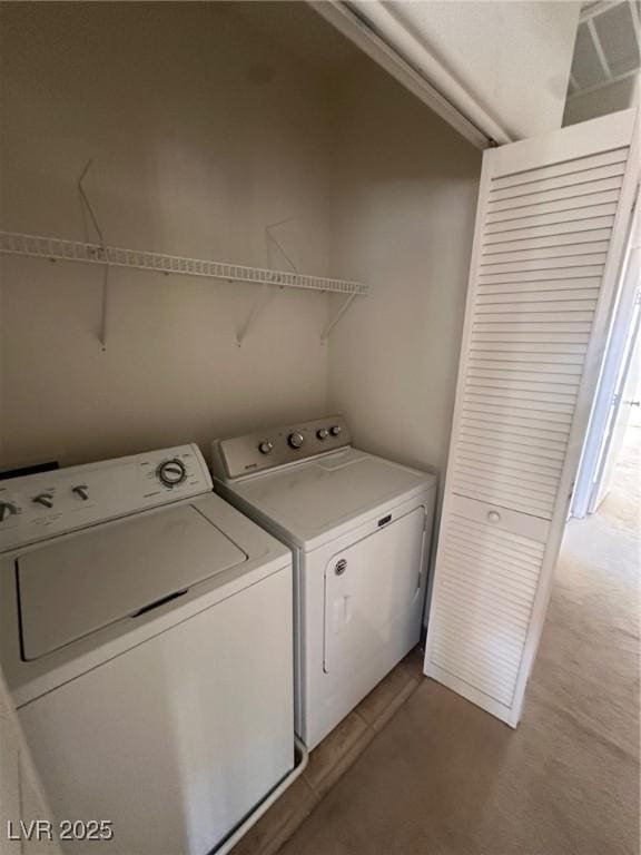 laundry area with washing machine and clothes dryer and laundry area