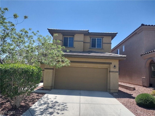 view of front of home featuring stucco siding, driveway, and a garage