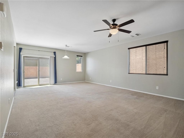 empty room with a ceiling fan, carpet flooring, and baseboards