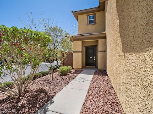doorway to property with stucco siding