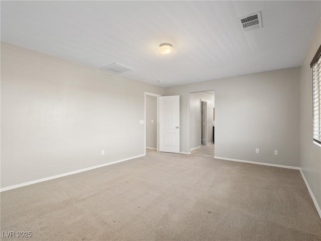 carpeted spare room featuring baseboards