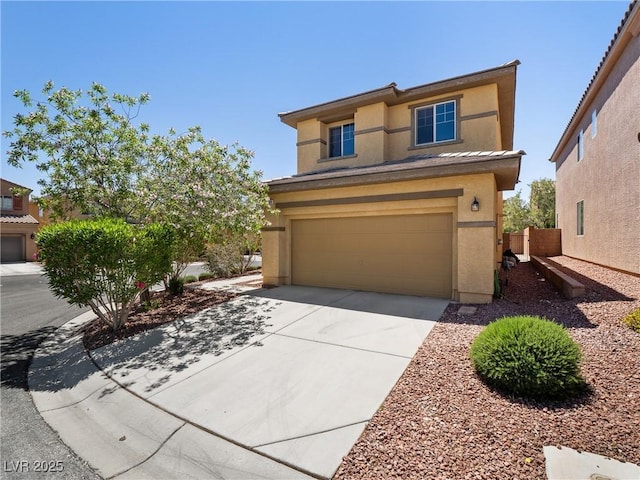 view of front of house with stucco siding, driveway, and a garage