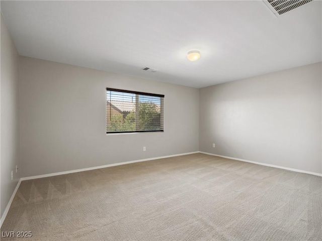 carpeted empty room with baseboards
