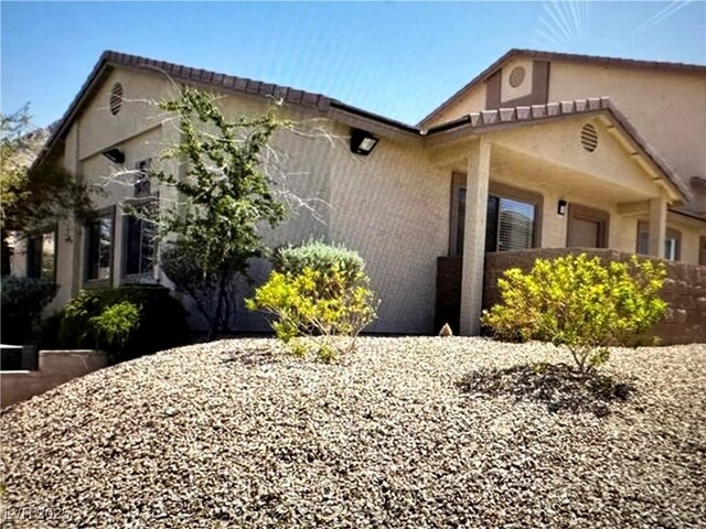 view of home's exterior with stucco siding and an attached garage