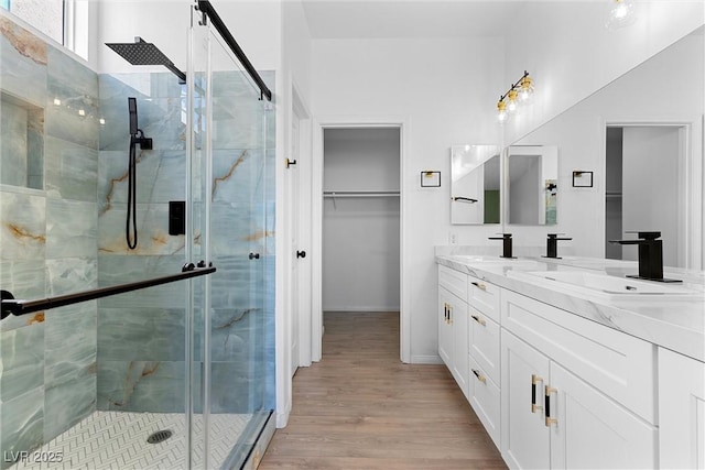 7957 Lovely Pine Pl, Las Vegas, NV 89143 - full bath featuring a stall shower, double vanity, wood finished floors, and a spacious closet