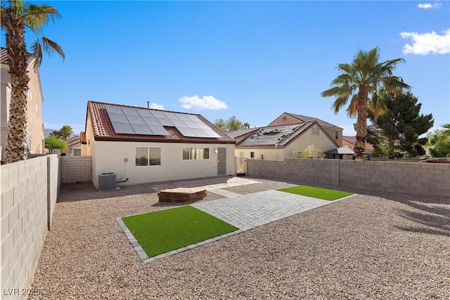 7957 Lovely Pine Pl, Las Vegas, NV 89143 - back of house with stucco siding, a patio area, solar panels, and a fenced backyard