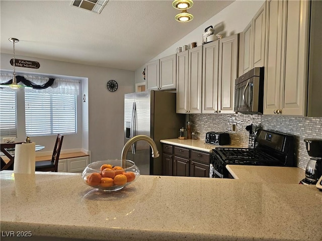 2022 Big Bend Way, Henderson, NV 89074 - kitchen with stainless steel appliances, vaulted ceiling, decorative backsplash, decorative light fixtures, and light stone counters