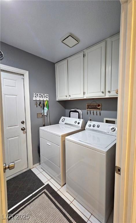 2022 Big Bend Way, Henderson, NV 89074 - laundry room featuring cabinet space, washing machine and clothes dryer, and light tile patterned floors