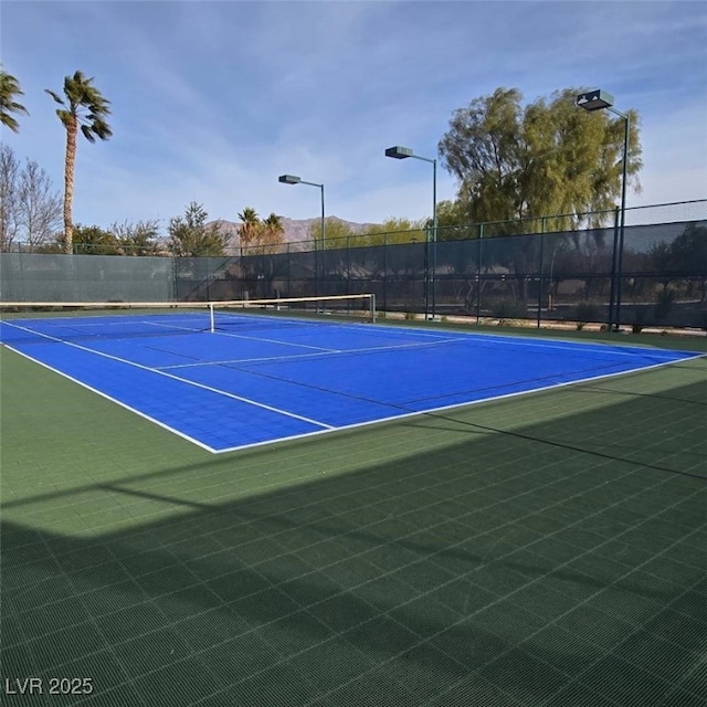 view of sport court with fence
