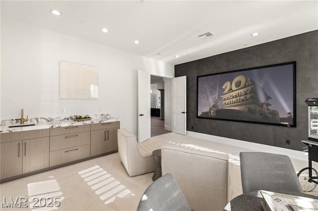 cinema room with visible vents, recessed lighting, and a sink