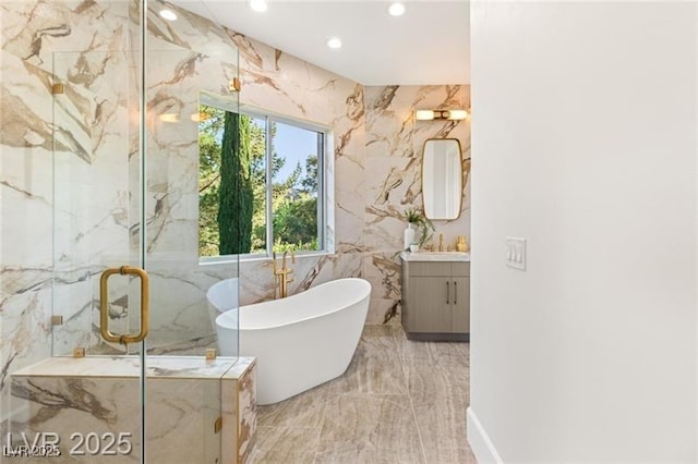 full bathroom with recessed lighting, marble finish floor, a freestanding bath, vanity, and a marble finish shower