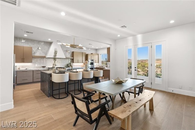 dining room featuring recessed lighting, visible vents, and light wood-type flooring