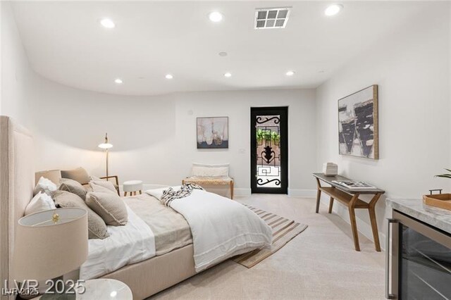 bedroom with a bar, beverage cooler, light colored carpet, visible vents, and recessed lighting