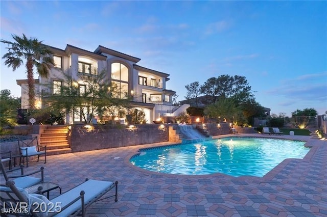 view of pool featuring a fenced in pool, a patio, and stairway