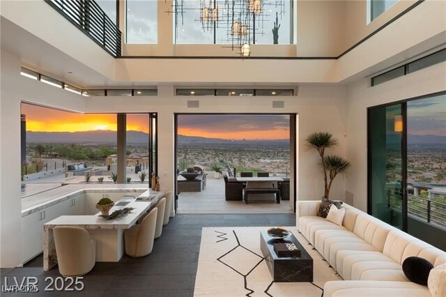 living area with a high ceiling and a healthy amount of sunlight