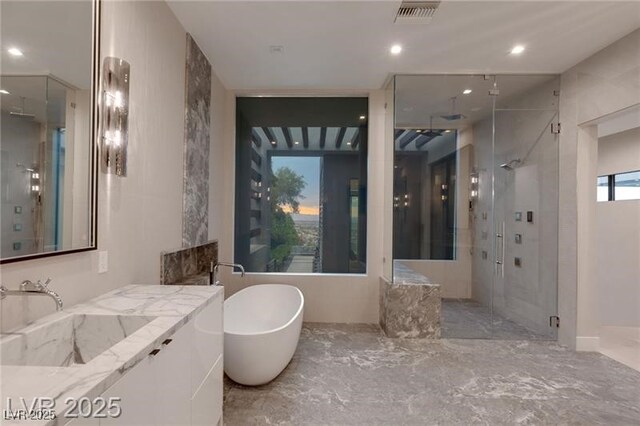 full bath with recessed lighting, a shower stall, visible vents, vanity, and a freestanding tub
