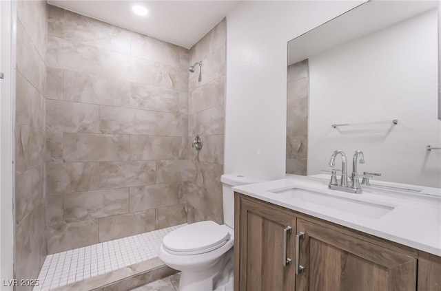 full bathroom with vanity, toilet, and tiled shower