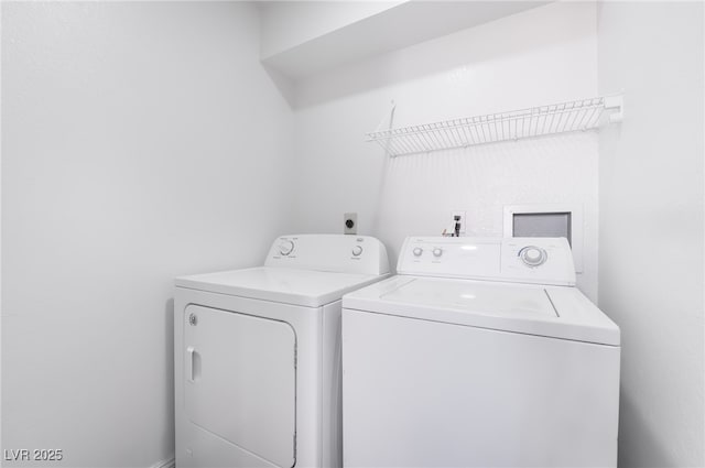 laundry area with washing machine and clothes dryer and laundry area