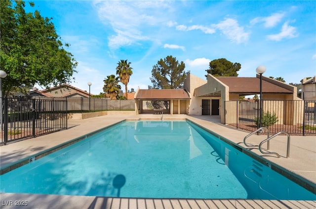 pool featuring fence and a patio