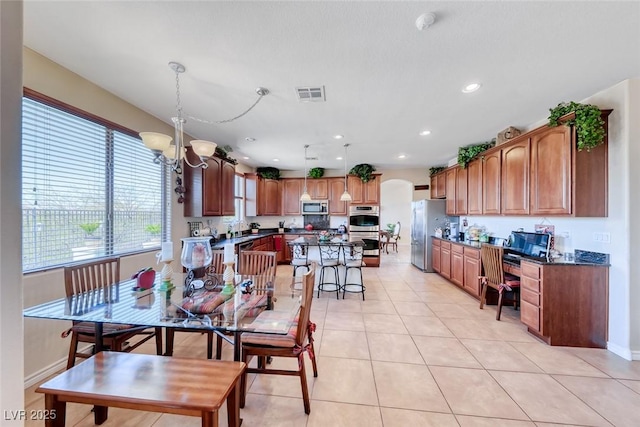 2733 Auchmull St, Henderson, NV 89044 - dining room with arched walkways, light tile patterned floors, a chandelier, and recessed lighting