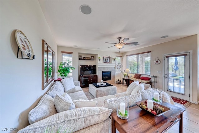 2733 Auchmull St, Henderson, NV 89044 - living room featuring healthy amount of natural light, light tile patterned flooring, a tile fireplace, and ceiling fan