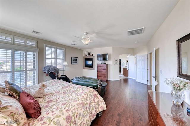 2733 Auchmull St, Henderson, NV 89044 - bedroom with arched walkways, dark wood finished floors, access to outside, and a ceiling fan
