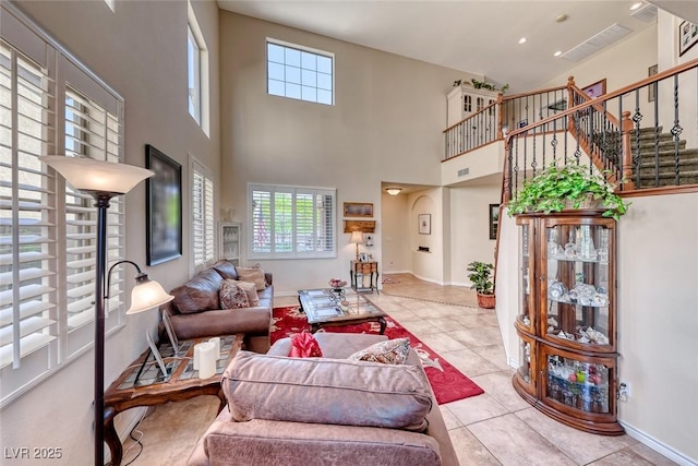 2733 Auchmull St, Henderson, NV 89044 - tiled living area with healthy amount of natural light, a towering ceiling, and stairway
