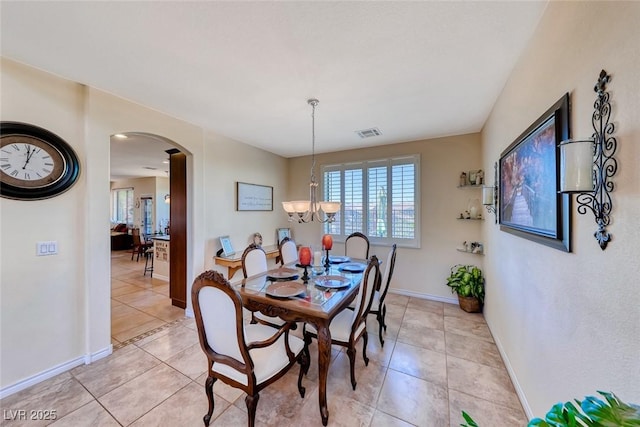 2733 Auchmull St, Henderson, NV 89044 - dining area with arched walkways, light tile patterned floors, and a chandelier