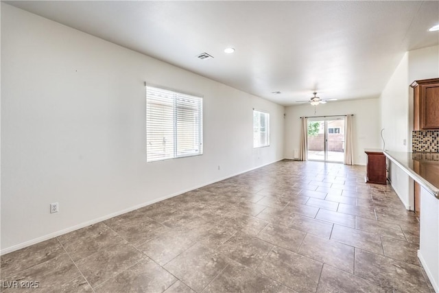 unfurnished living room featuring ceiling fan, baseboards, and visible vents