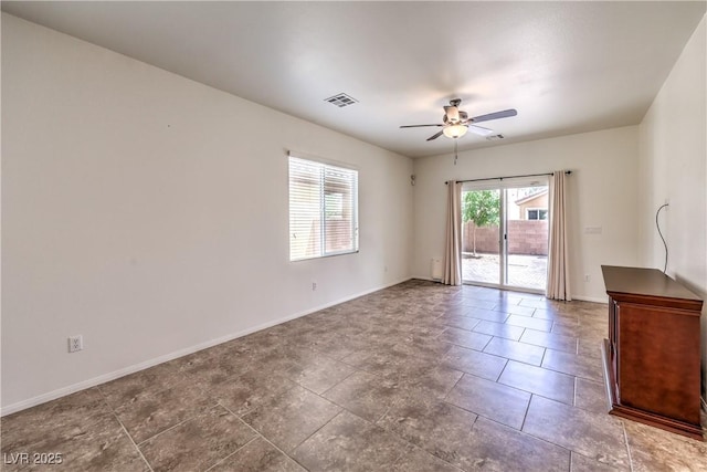 unfurnished room featuring visible vents, baseboards, and ceiling fan