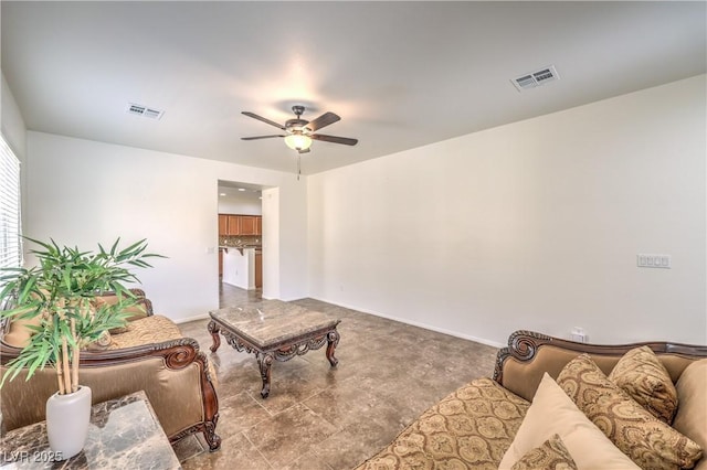 living area with ceiling fan, baseboards, and visible vents