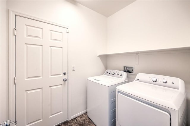 laundry area with washer and clothes dryer, baseboards, and laundry area